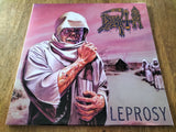 Album cover with a person in a hood and text 'LEPROSY' on a pink background